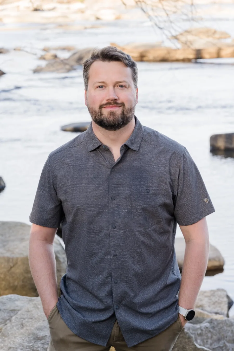 Daniel Owen, LPC, standing by the rocks of the James River