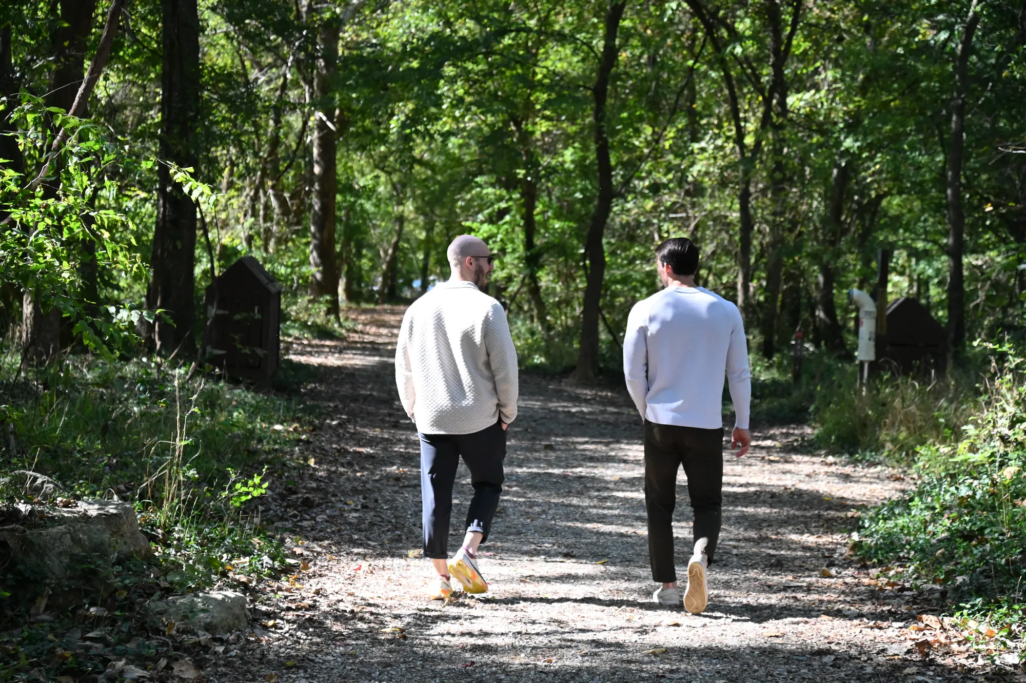 Two men walking on down a wooded James River trail