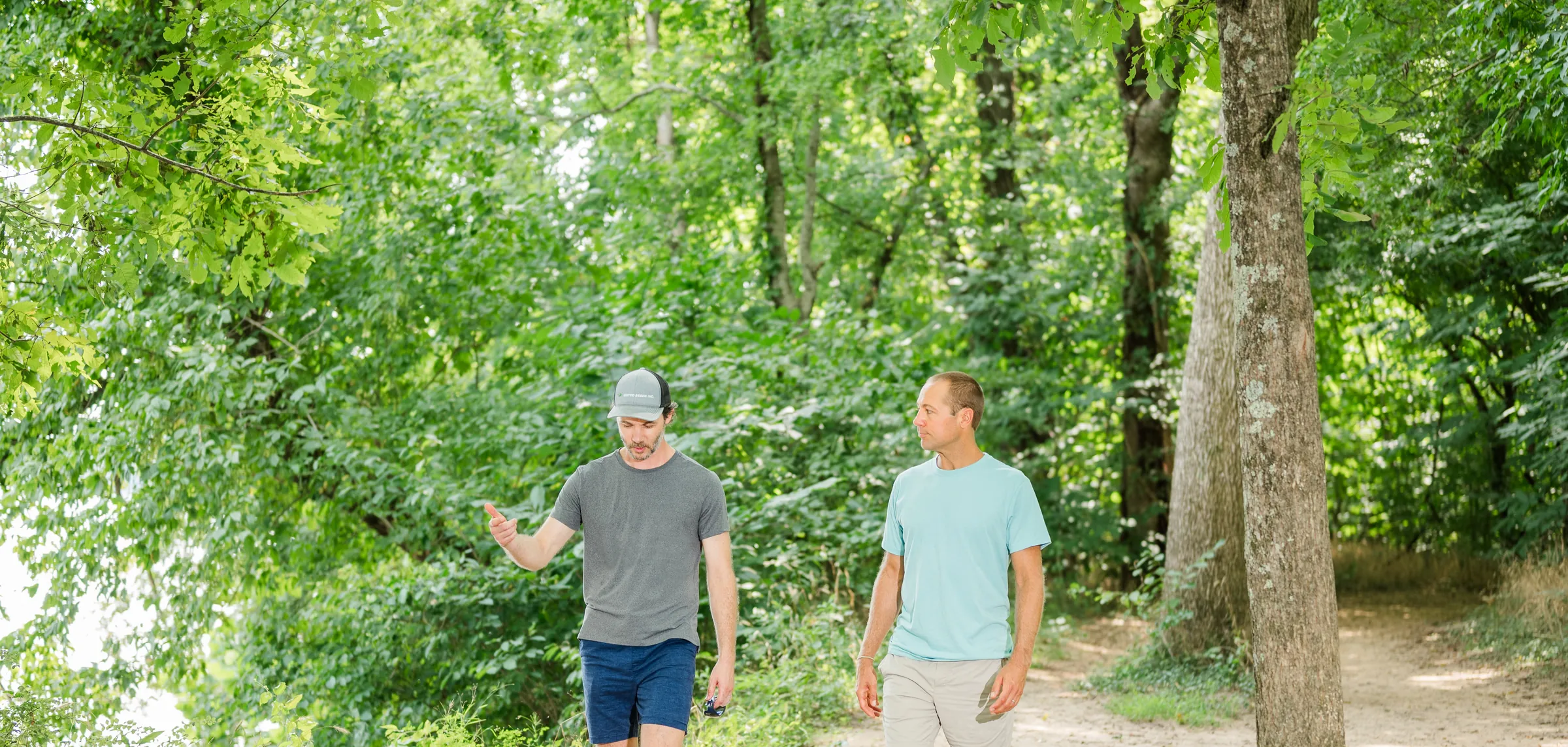 Two men in conversation while walking a James River Park trail